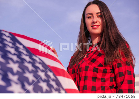 Young millennial brunette woman holding The National Flag of USA. American Flag. Tourist traveler or patriotism. Immigrant in free country. July 4th Independence Day. Caucasian 78471068