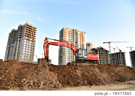 Excavator on earthworks at construction site.  78477665