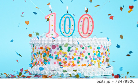 Colorful tasty birthday cake with candles shaped like the number 100. 78479906