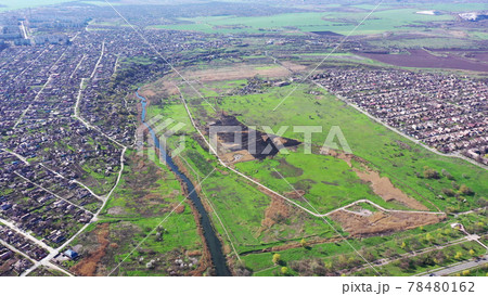 A field after a fire near the river. Aerial view. Residential areas from a bird's eye view 78480162