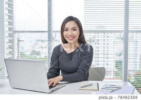 A beautiful lady sitting at a table. Office life. Work place. A beautiful lady sitting at a table. Office life. Work place. 78482369