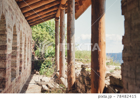 Fragment of the old fortress wall with windows overlooking the sea coast Fragment of the old fortress wall with windows overlooking the sea coast 78482415