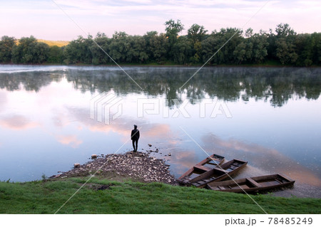Majestic foggy river and old wooden boats at sunrise Majestic foggy river and old wooden boats at sunrise 78485249