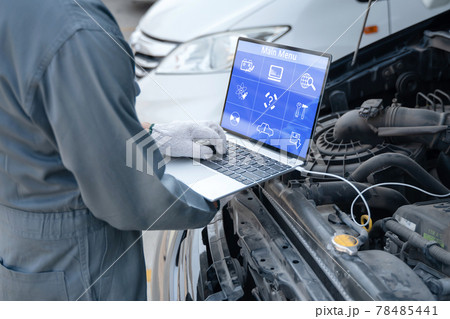 Mechanic using a laptop computer to check collect information during work a car engine. service maintenance of industrial to engine repair. Mechanic using a laptop computer to check collect information during work a car engine. service maintenance of industrial to engine repair. 78485441