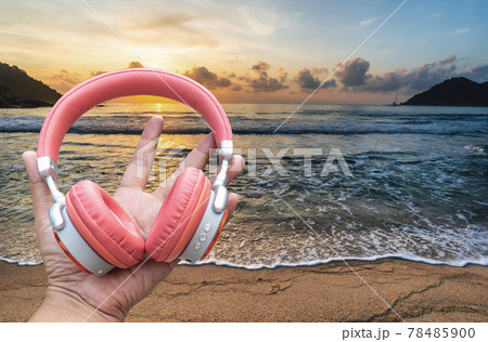 Hand Wifi headphones technology and nature, a new system in 9 d sound technology, Headphones of different types flat lay. Hand Wifi headphones technology and nature, a new system in 9 d sound technology, Headphones of different types flat lay. 78485900