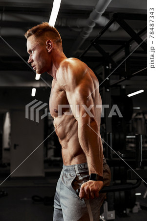 Closeup portrait of a muscular man workout with barbell at gym. Brutal bodybuilder athletic man with six pack, perfect abs, shoulders, biceps, triceps and chest Closeup portrait of a muscular man workout with barbell at gym. Brutal bodybuilder athletic man with six pack, perfect abs, shoulders, biceps, triceps and chest 78487343