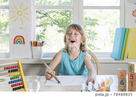 Funny beautiful happy child boy draws laughing with paint. 78489835