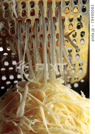 Grated cheese and grater. Grated cheese and grater. 78490083