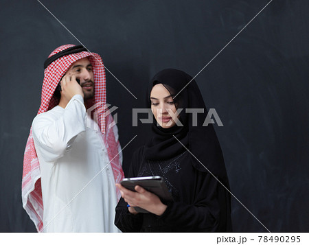 Young muslim business couple using technology devices 78490295