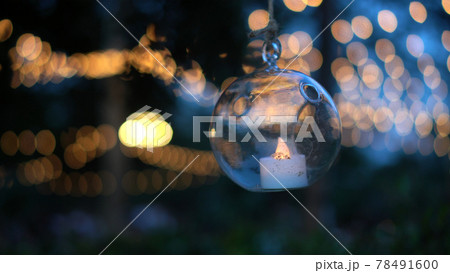 Beautiful evening garden party glass ornaments with candle bokeh festive light background 78491600