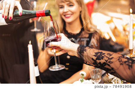 Crop women pouring wine during party Crop women pouring wine during party 78491908