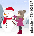 Girl making snowman that wearing a scarf in winter 78492417