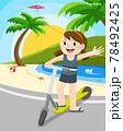 Girl riding kick scooter at beach  78492425