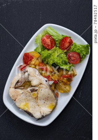 boiled fish with vegetables and fresh salad on white dish 78492517