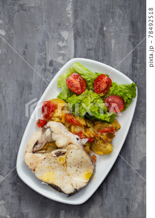 boiled fish with salad on white dish 78492518