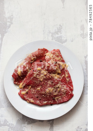 raw meat with spices on white dish raw meat with spices on white dish 78492565