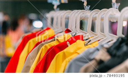 autumn-spring jackets of different colors hang on a hanger in the store autumn-spring jackets of different colors hang on a hanger in the store 78493195