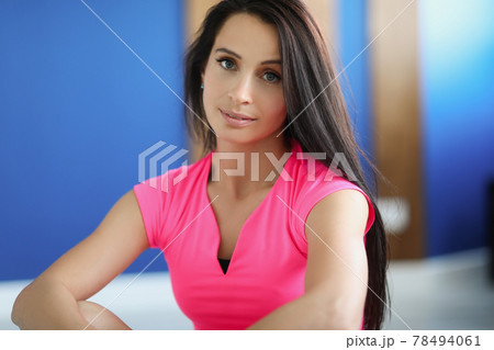 Portrait of young brunette woman in pink sports shirt Portrait of young brunette woman in pink sports shirt 78494061
