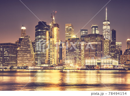 Manhattan skyline at night, color toning applied, New York City, USA. 78494154