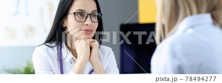 Portrait of doctor listening to patient at appointment Portrait of doctor listening to patient at appointment 78494277