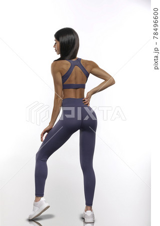 girl in purple leggings and top stay back on a white background 78496600