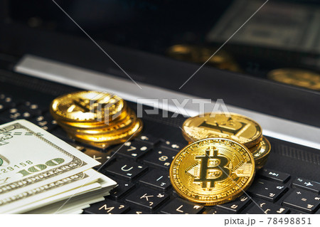 Bitcoins coin and banknotes on keyboard compute 78498851