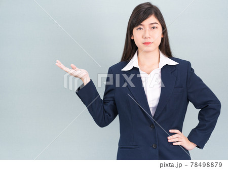 Asian woman in suit open hand palm gestures with empty space 78498879