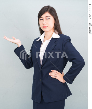 Asian woman in suit open hand palm gestures with empty space Asian woman in suit open hand palm gestures with empty space 78498881