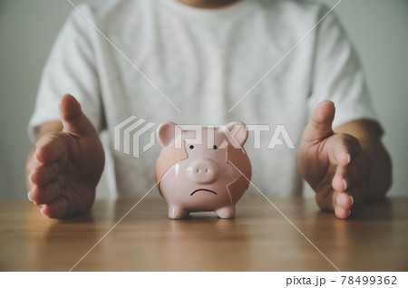 Man hand protect piggy bank on wood table. Save money and financial investment Man hand protect piggy bank on wood table. Save money and financial investment 78499362