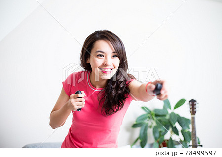 woman play motion sensing game woman play motion sensing game 78499597