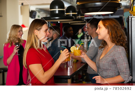 Two young women with cocktails having fun on party at nightclub Two young women with cocktails having fun on party at nightclub 78502692