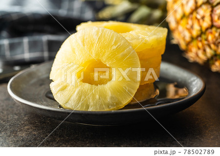 Canned sliced pineapple fruit on plate. Canned sliced pineapple fruit on plate. 78502789