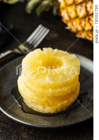 Canned sliced pineapple fruit on plate. Canned sliced pineapple fruit on plate. 78502790