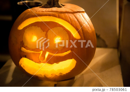 Orange glowing halloween carved pumpkin 78503061