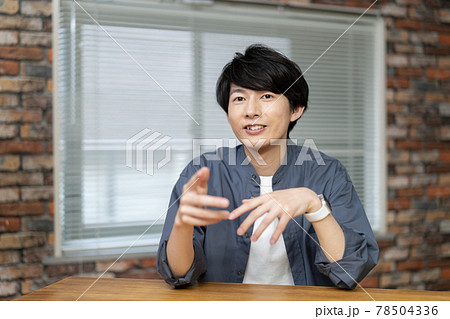 カメラ目線で話す20代前半の男性　 78504336