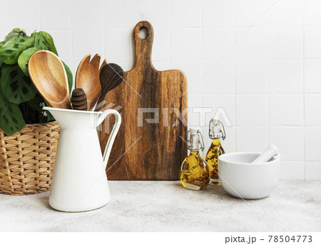 Kitchen utensils, tools and dishware on on the background white tile wall. Kitchen utensils, tools and dishware on on the background white tile wall. 78504773