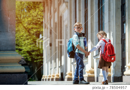 Kids boy and girl go back to school. Brother and sister with backpacks and books going to school after summer vacation. Students protect and safety from coronavirus after pandemic. New school year. Kids boy and girl go back to school. Brother and sister with backpacks and books going to school after summer vacation. Students protect and safety from coronavirus after pandemic. New school year. 78504957