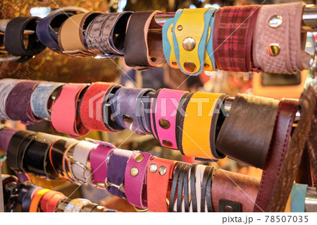 A counter with different handmade leather bracelets. 78507035