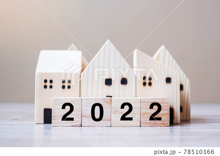 2022 Happy New Year with house model on table wooden background. Banking, real estate, investment, financial, savings and New Year Resolution concepts 78510366