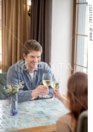 Man with glass of wine and woman celebrating event Man with glass of wine and woman celebrating event 78511057