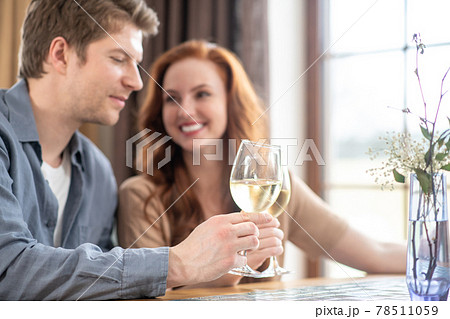 Happy couple with glasses of wine in restaurant Happy couple with glasses of wine in restaurant 78511059