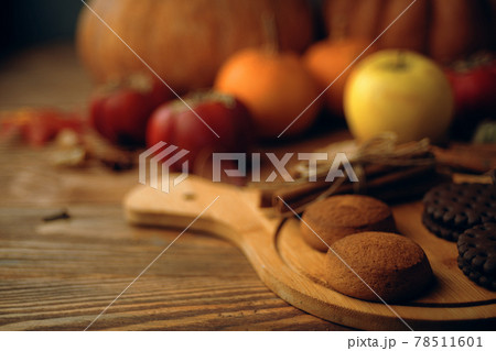 Cookies with pumpkins and apples on the table. 78511601