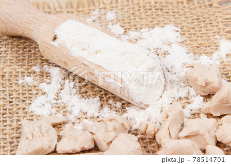 Fresh crumbled yeast and flour on wooden scoop for baking or cooking Fresh crumbled yeast and flour on wooden scoop for baking or cooking 78514701