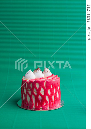 Vertical shot of small red cupcake with creamy topping. Vertical shot of small red cupcake with creamy topping. 78514757