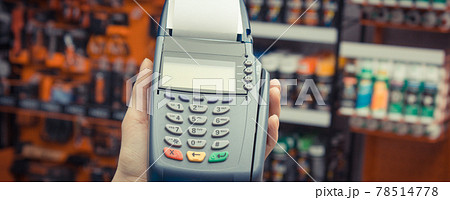 Hand of woman using payment terminal with credit card. Cashless paying for shopping in shop Hand of woman using payment terminal with credit card. Cashless paying for shopping in shop 78514778