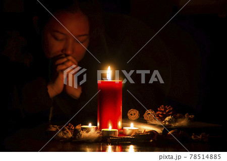 Woman Praying and worship to GOD Using hands to pray in religious beliefs and worship christian with Red Candle with fire against defocused lights in darkness with in the dark Background Woman Praying and worship to GOD Using hands to pray in religious beliefs and worship christian with Red Candle with fire against defocused lights in darkness with in the dark Background 78514885
