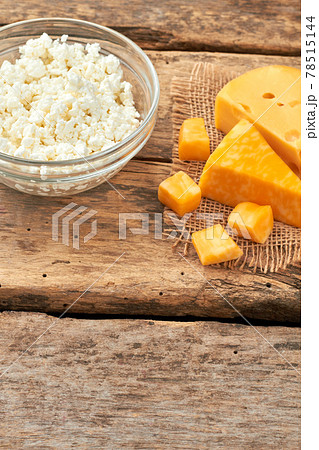 Assortment of fresh cheese on old wood. 78515144