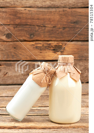 Milk and sour cream on wooden background. Milk and sour cream on wooden background. 78515304