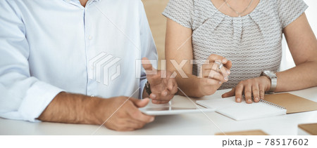Unknown businessman and woman working with computer in a modern office, close-up. Group of diverse people. Teamwork, partnership and business concept Unknown businessman and woman working with computer in a modern office, close-up. Group of diverse people. Teamwork, partnership and business concept 78517602