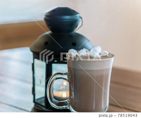 Cup of cocoa with marshmallows is standing on the wooden table. Close-up. Still life 78519043
